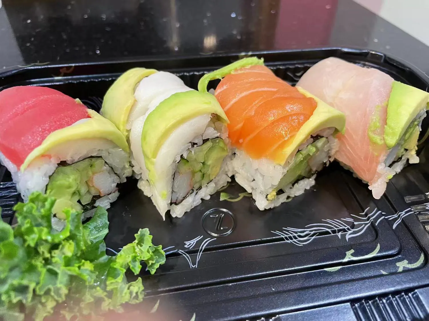 Rainbow avocado sushi roll with assorted fresh fish at Kumo Sushi & Hibachi, a Japanese Restaurant in Alachua